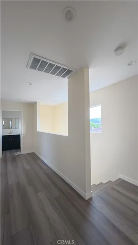 a white vase with white and yellow flowers
