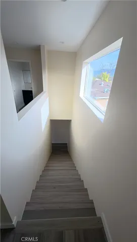a view of a hallway to dining room with wooden floor