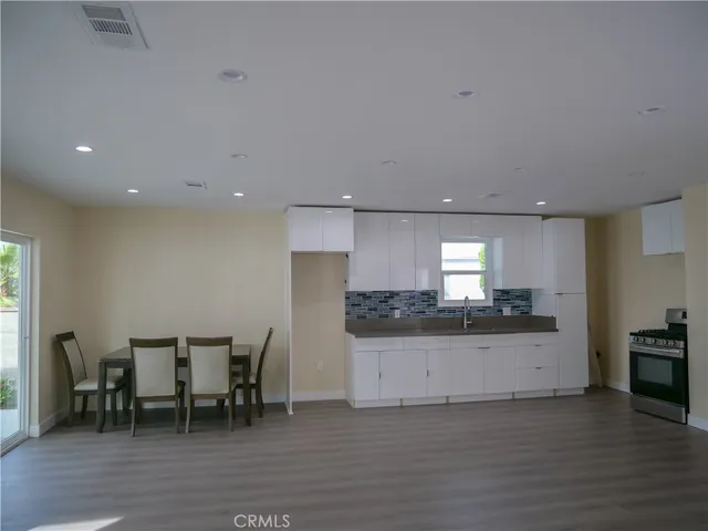 a stove top oven sitting inside of a kitchen