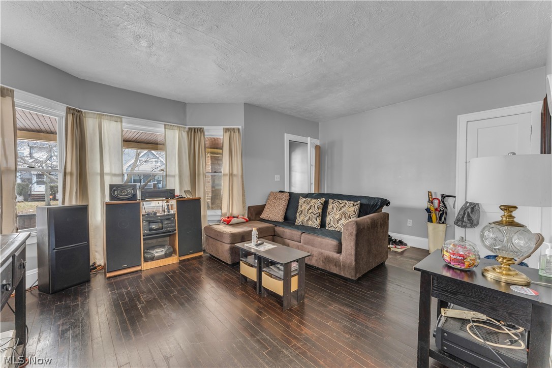 860 Greyton Road Cleveland Heights, OH 44112 - Photo 8 of 31 Living room featuring dark hardwood / wood-style floors and a textured ceiling