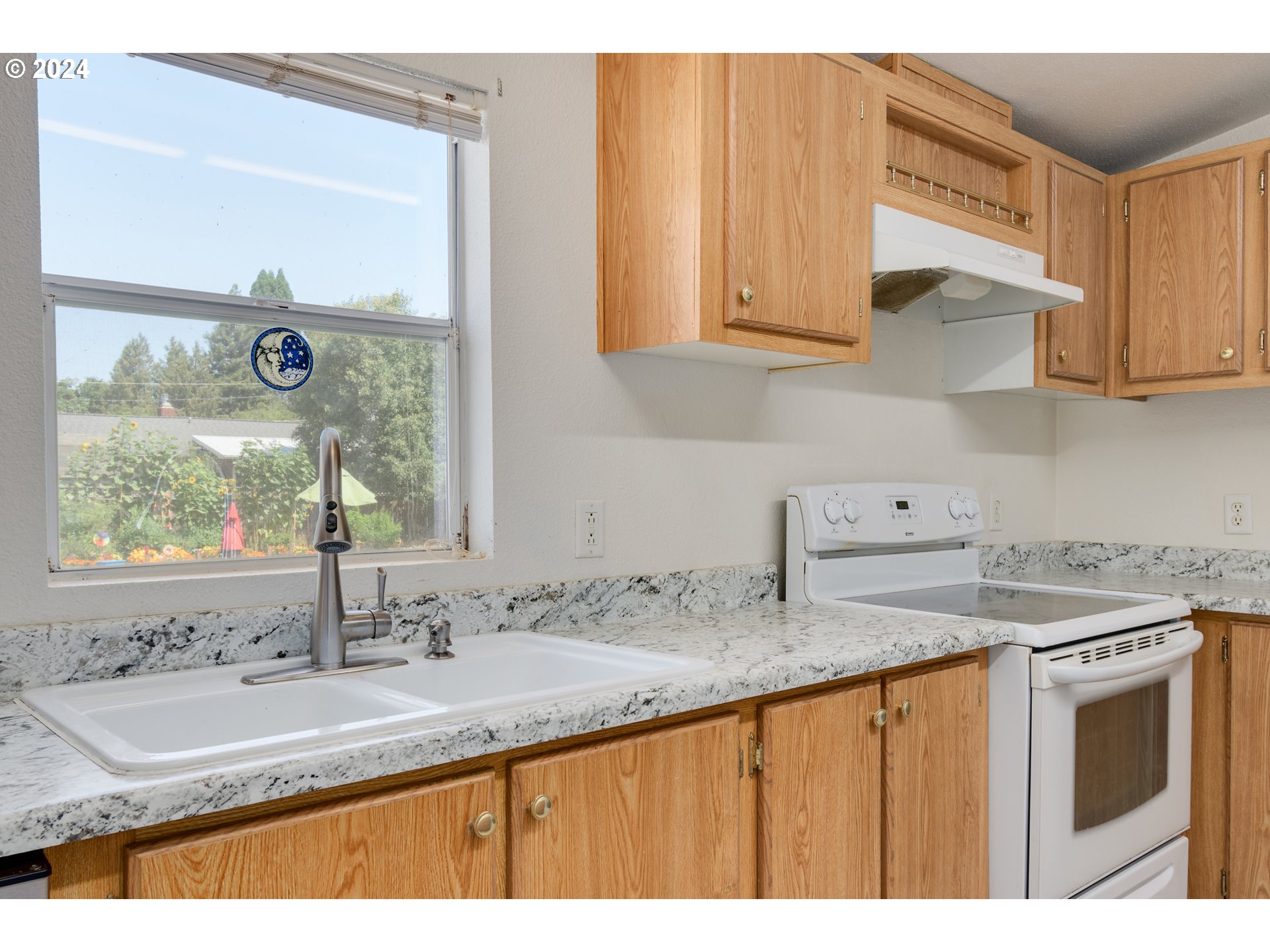 2893 Ava Street Eugene, OR 97404 - Photo 12 of 29 a kitchen with stainless steel appliances granite countertop a sink and a wooden cabinets