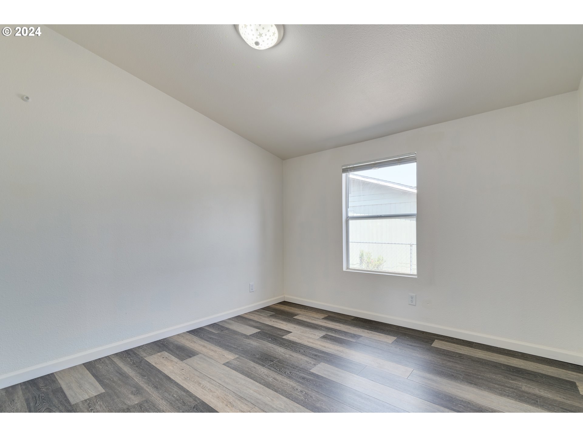 2893 Ava Street Eugene, OR 97404 - Photo 21 of 29 an empty room with wooden floor and windows