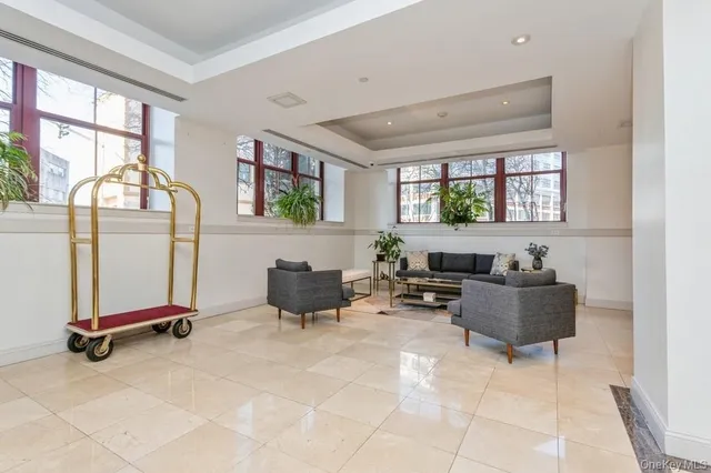 a living room with furniture gym equipment and a large window