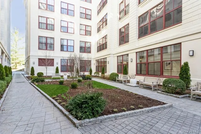a view of a building with garden and sitting area