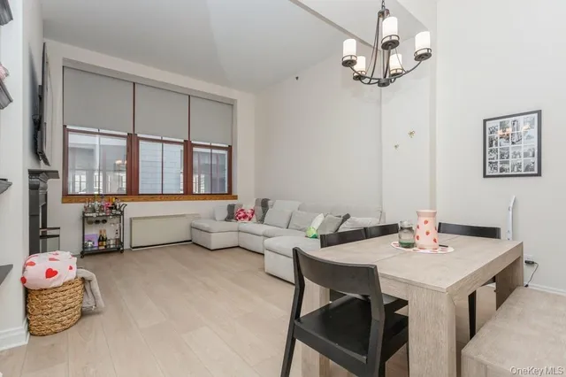 a dining room with furniture and chandelier