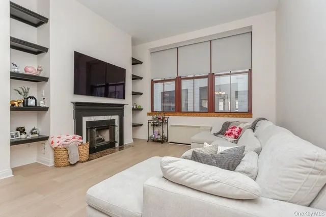 a living room with furniture fireplace and flat screen tv