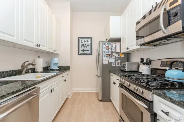a kitchen with stainless steel appliances granite countertop a stove and a sink