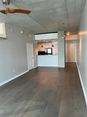 a view of a room with wooden floor