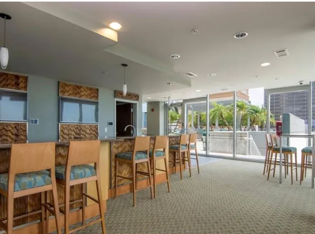 a swimming pool with outdoor seating and a potted plants