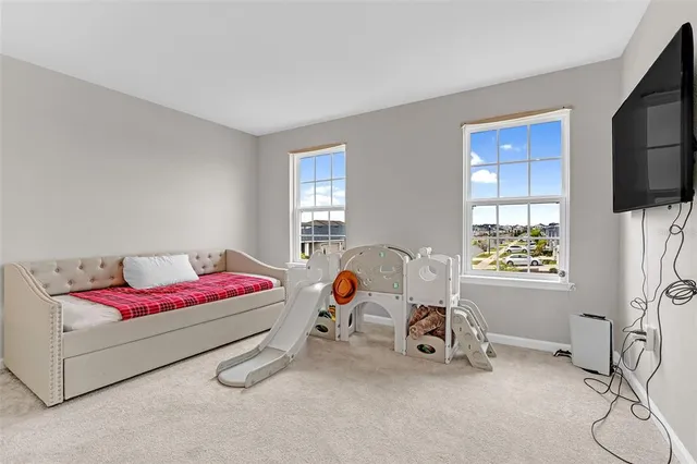 a living room with furniture a window and gym equipment