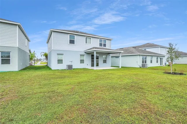 a view of a house with a garden and yard