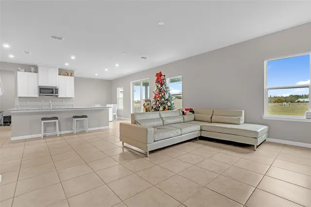 a living room with furniture and a kitchen view