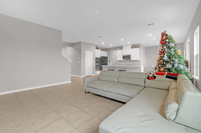 a living room with furniture and flowers