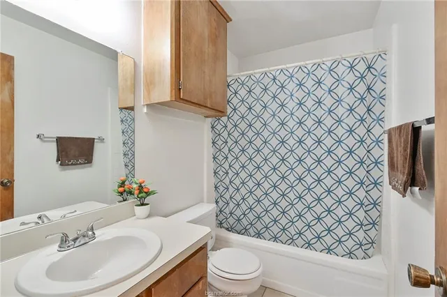 a bathroom with a sink and a mirror with toilet