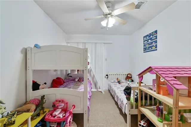 a bedroom with furniture and a baby crib