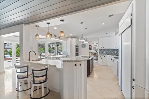 a kitchen with a stove a sink and a refrigerator