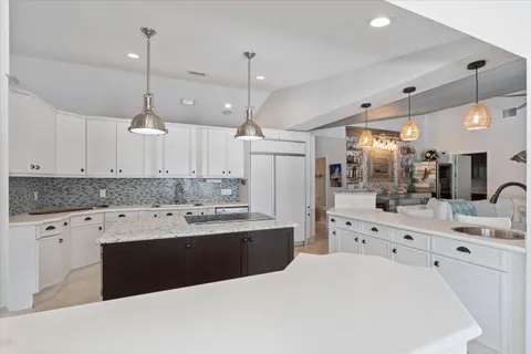 a kitchen with granite countertop a stove and a microwave oven