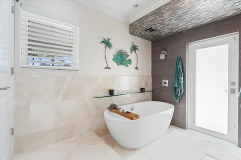 a bathroom with a granite countertop bathtub shower sink and mirror
