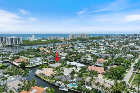 an aerial view of residential houses with outdoor space and lake view