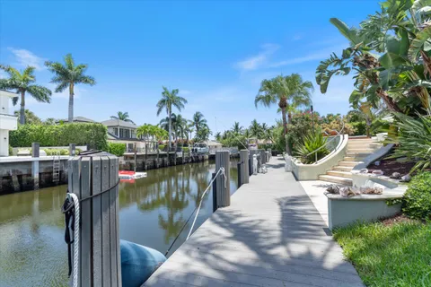 an aerial view of residential houses with outdoor space and lake view