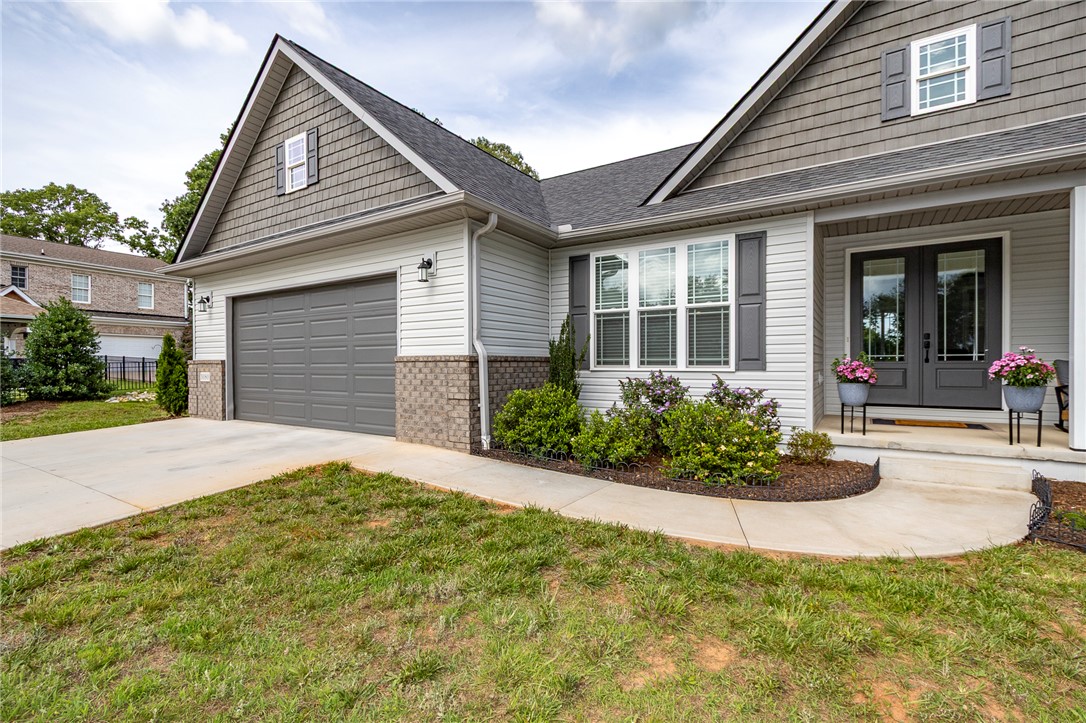 3080 McGee Road Iva, SC 29655 - Photo 5 of 49 A welcoming facade features a well-maintained lawn and an inviting entryway.