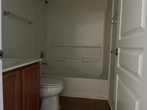 a view of staircase with white walls and white door