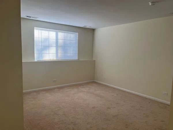 a view of a street with a yard and a large tree