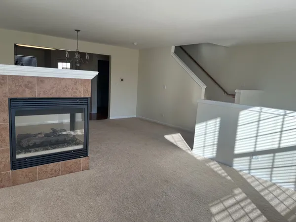 a view of empty room with a fireplace
