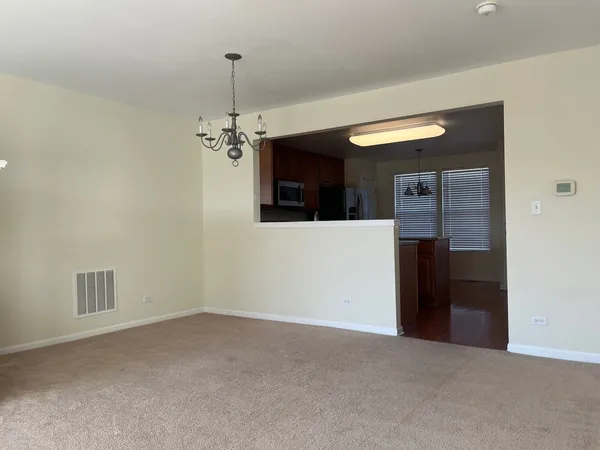 a kitchen with stainless steel appliances granite countertop a stove refrigerator and microwave