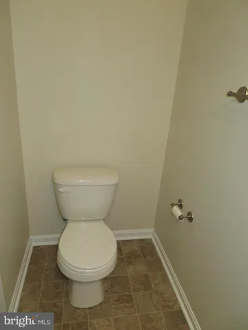 a white toilet sitting next to a white sink