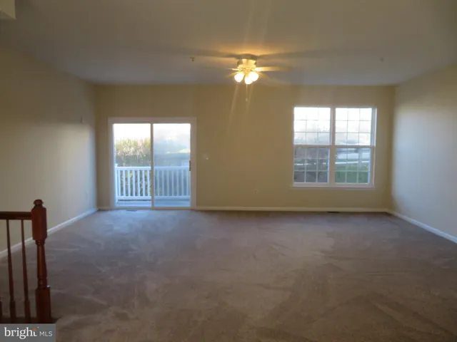 an empty room with windows and entrance