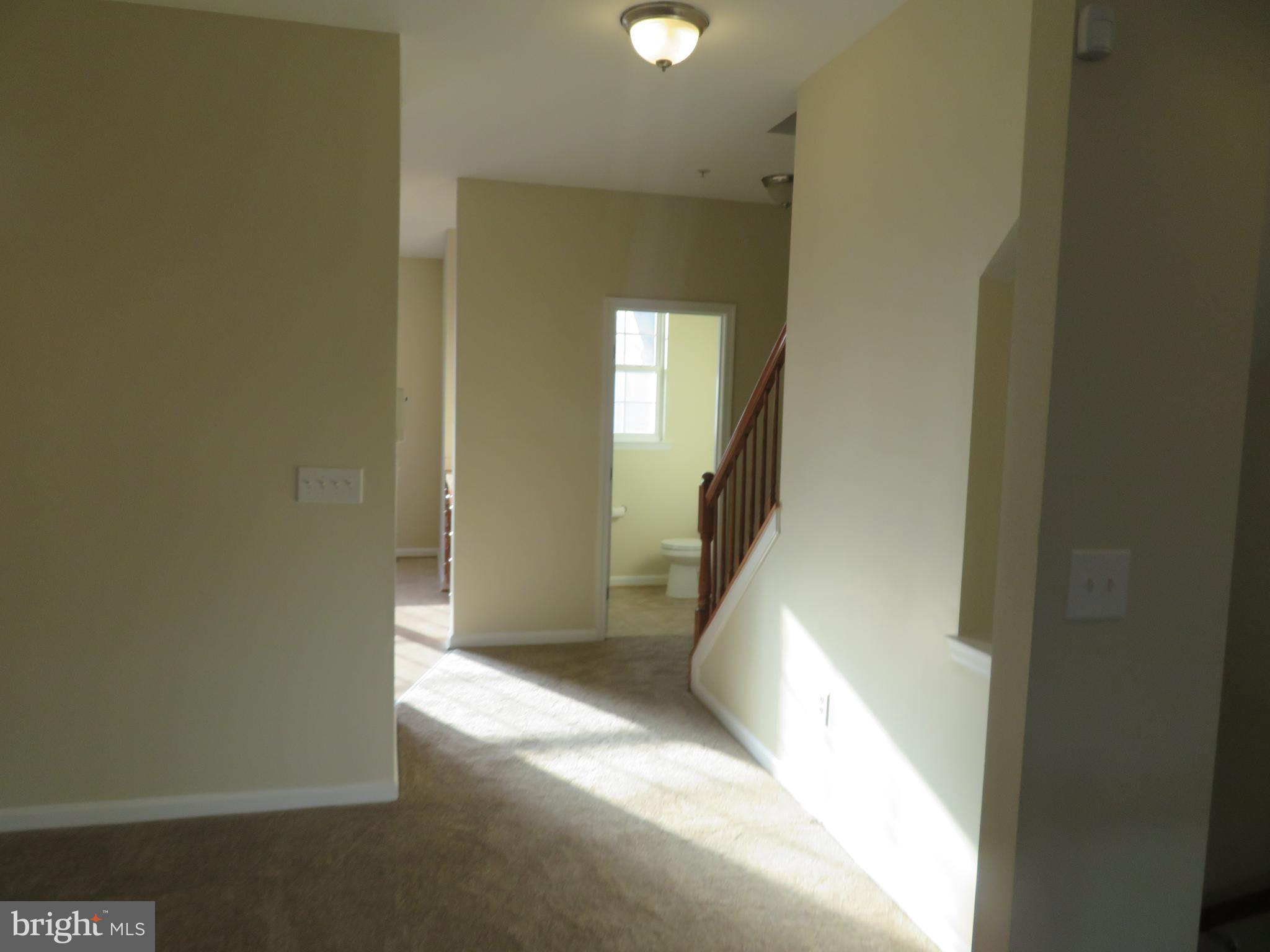 3700 Bedford Drive North Beach, MD 20714 - Photo 19 of 53 a view of a hallway with wooden floor and a living room