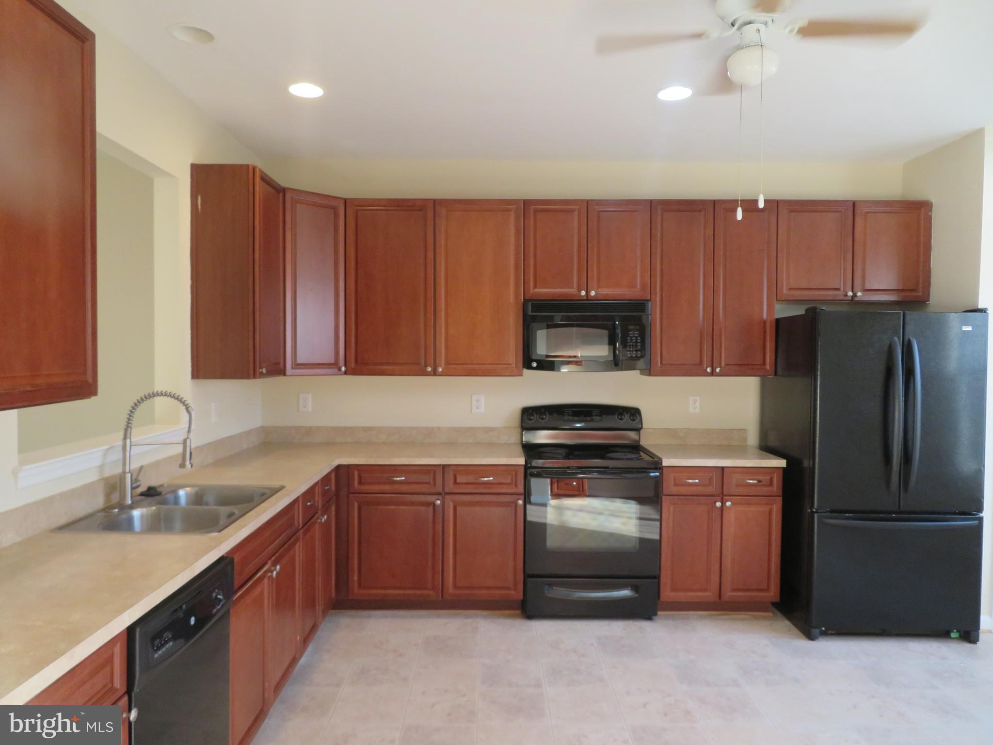 3700 Bedford Drive North Beach, MD 20714 - Photo 20 of 53 a kitchen with stainless steel appliances granite countertop a refrigerator stove a sink and dishwasher