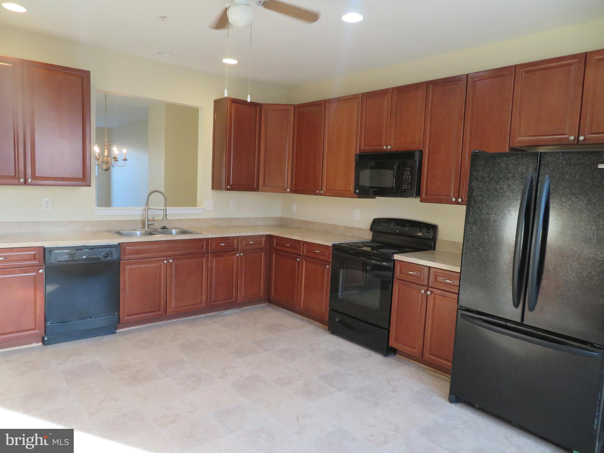 3700 Bedford Drive North Beach, MD 20714 - Photo 22 of 53 a kitchen with stainless steel appliances granite countertop a refrigerator stove top oven a sink and dishwasher