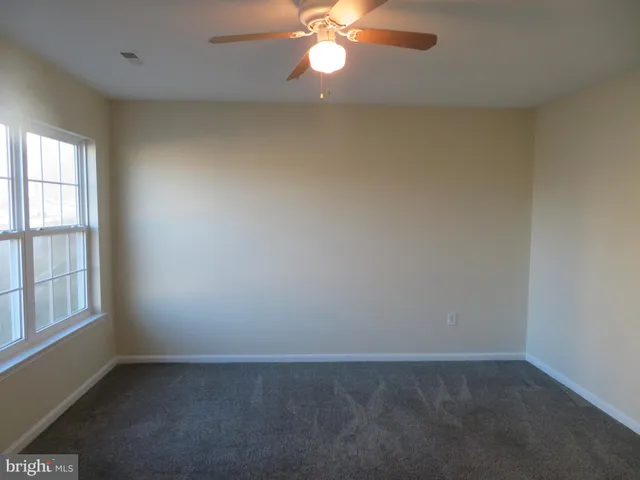 a view of a room with shelf on the wall