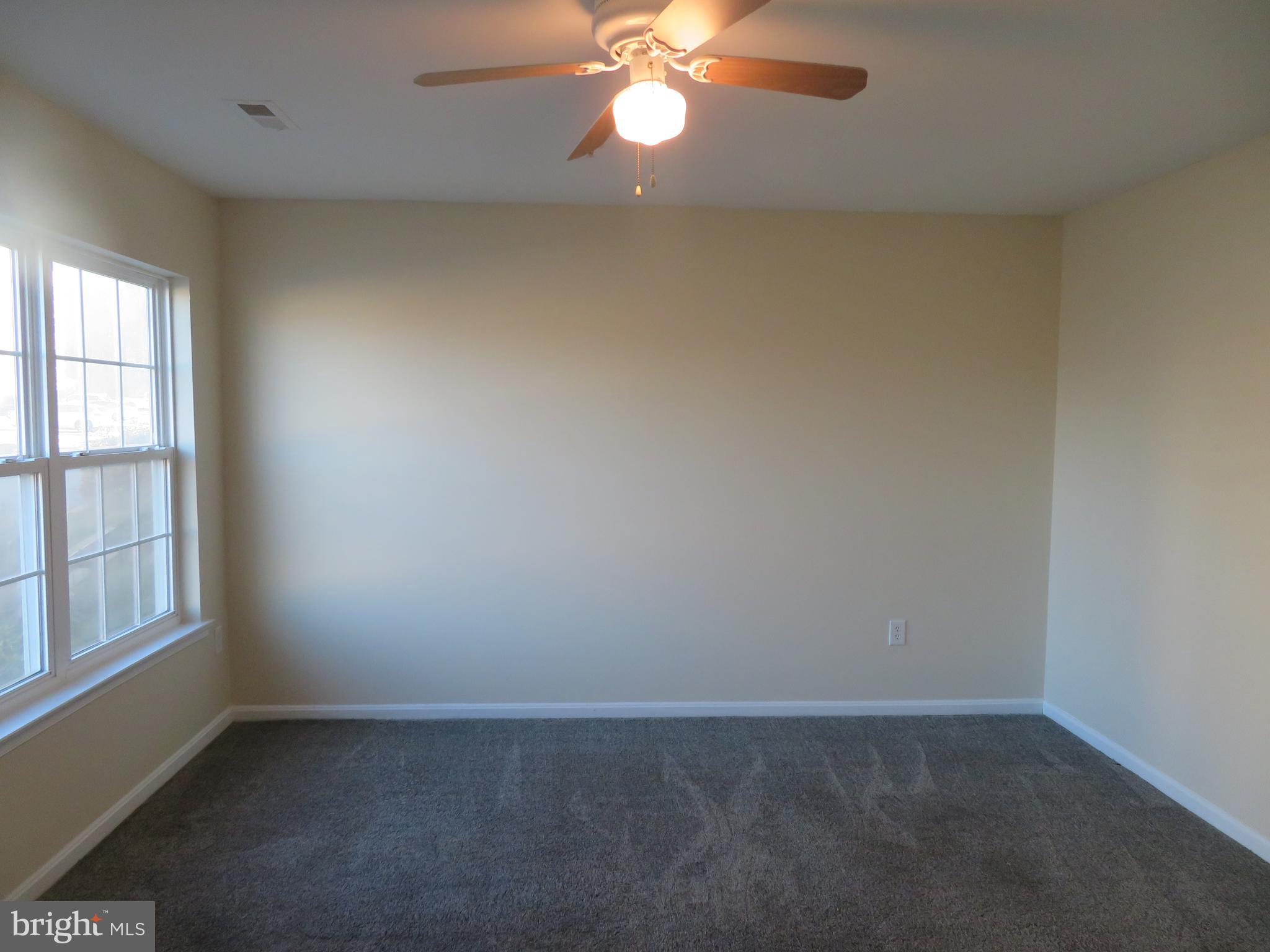 3700 Bedford Drive North Beach, MD 20714 - Photo 28 of 53 an empty room with windows and fan