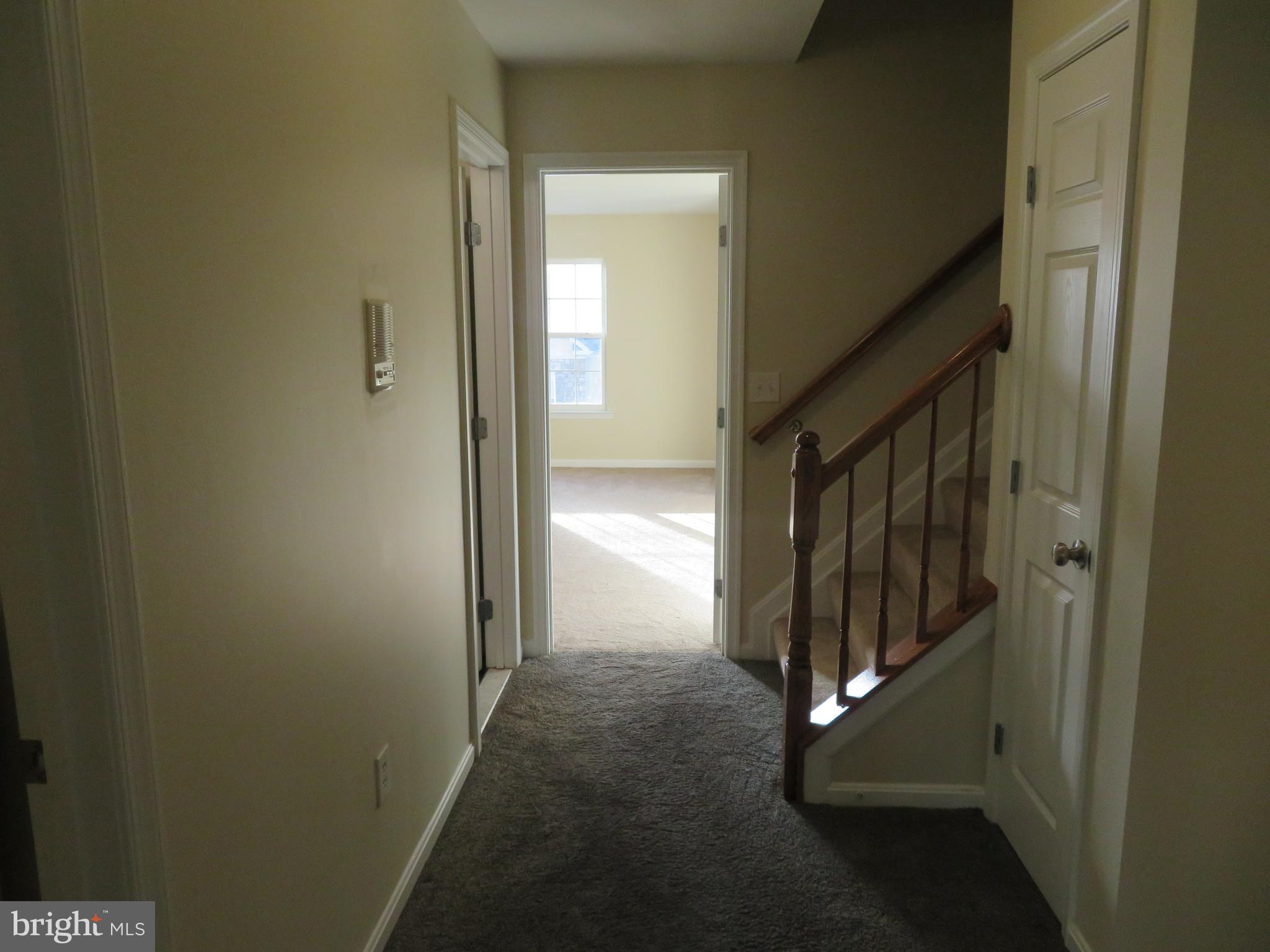 3700 Bedford Drive North Beach, MD 20714 - Photo 31 of 53 a view of a hallway with wooden walls and door