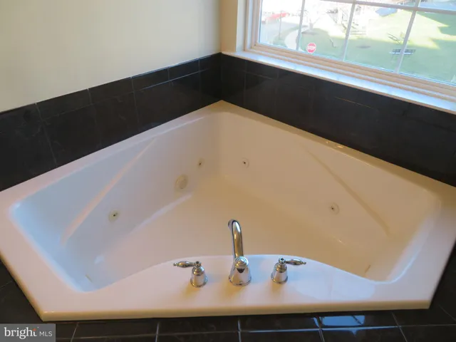 a white toilet sitting next to a white wall