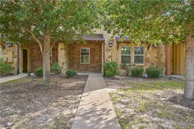 a view of a large trees in front of a house
