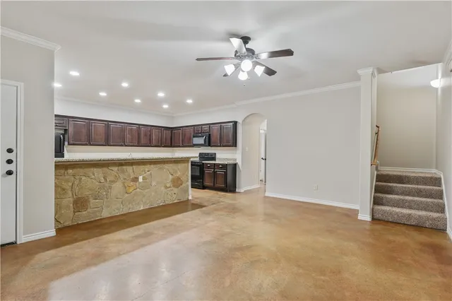 a view of a kitchen with furniture and an empty room