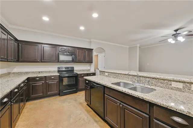 a kitchen with stainless steel appliances granite countertop a sink stove and refrigerator