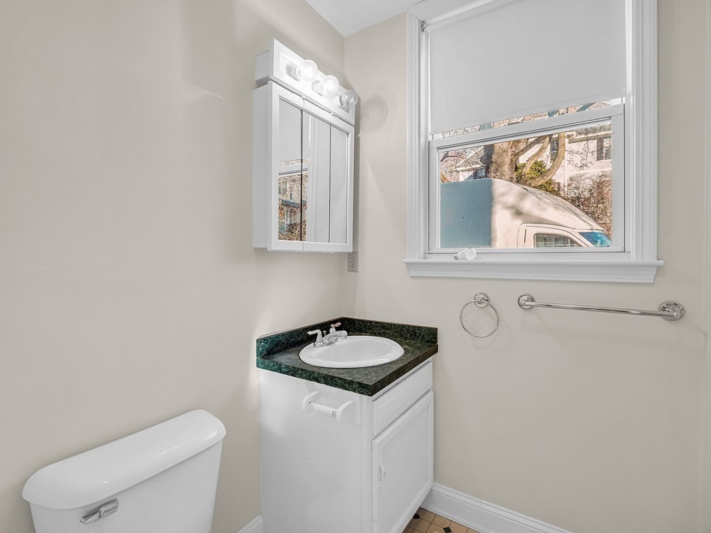 775 Bridge Street Lowell, MA 01850 - Photo 14 of 42 a bathroom with a granite countertop sink and a toilet