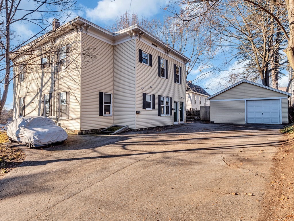 775 Bridge Street Lowell, MA 01850 - Photo 2 of 42 a view of a house with a yard and plants