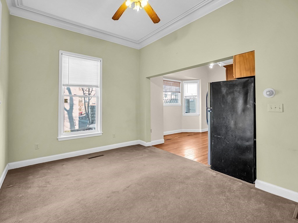 775 Bridge Street Lowell, MA 01850 - Photo 24 of 42 a view of an empty room with chandelier fan and fire place