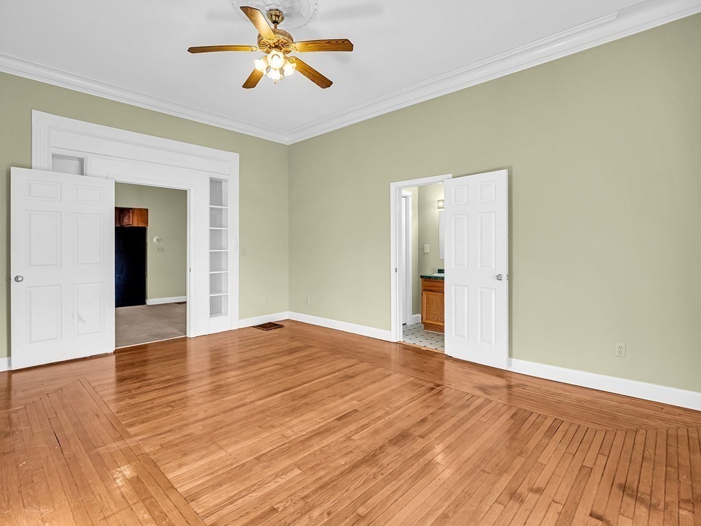 775 Bridge Street Lowell, MA 01850 - Photo 26 of 42 a view of an empty room with wooden floor and a window
