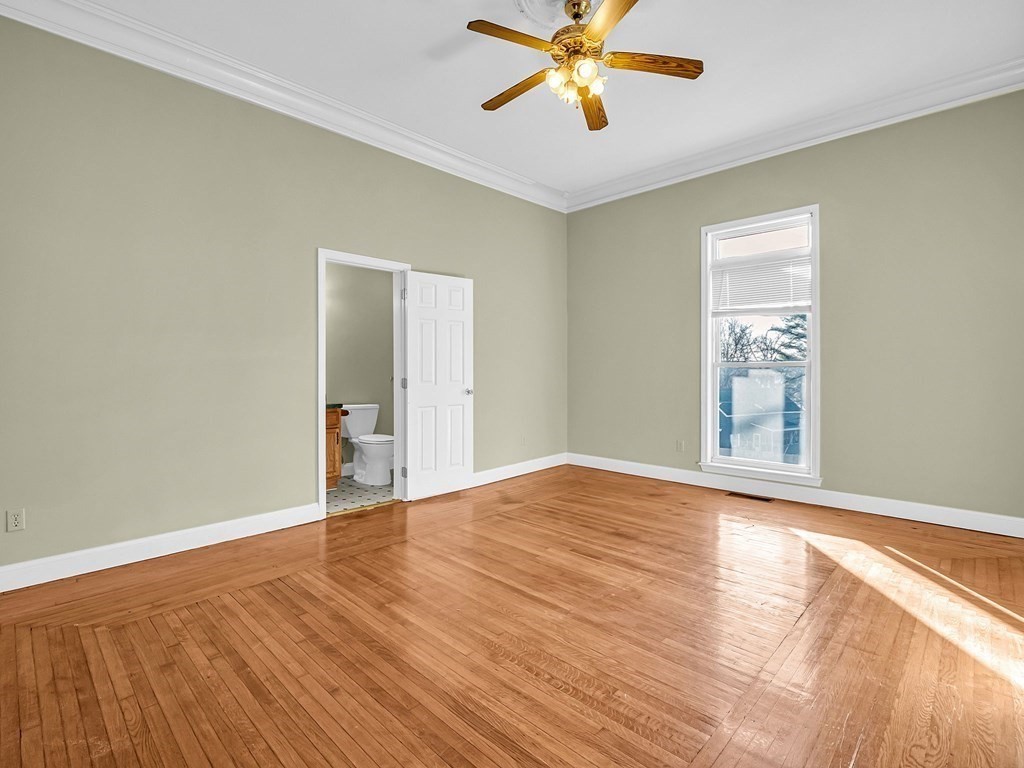 775 Bridge Street Lowell, MA 01850 - Photo 27 of 42 a view of an empty room with wooden floor and a window