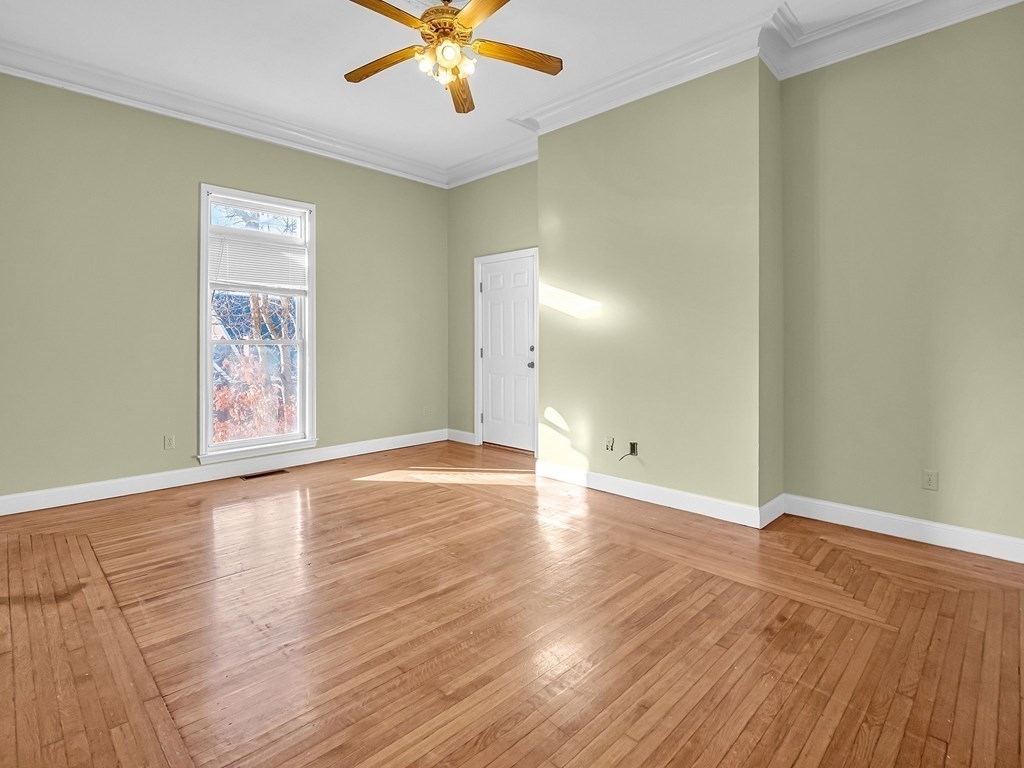 775 Bridge Street Lowell, MA 01850 - Photo 29 of 42 an empty room with wooden floor and windows