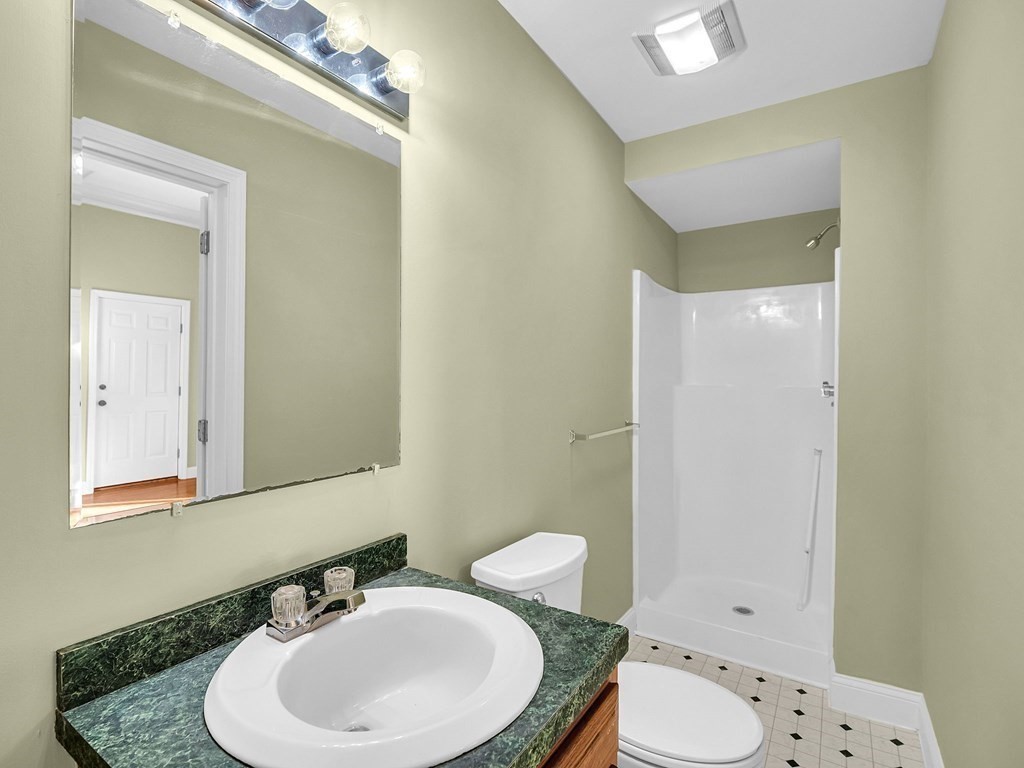 775 Bridge Street Lowell, MA 01850 - Photo 30 of 42 a bathroom with a sink a toilet and mirror