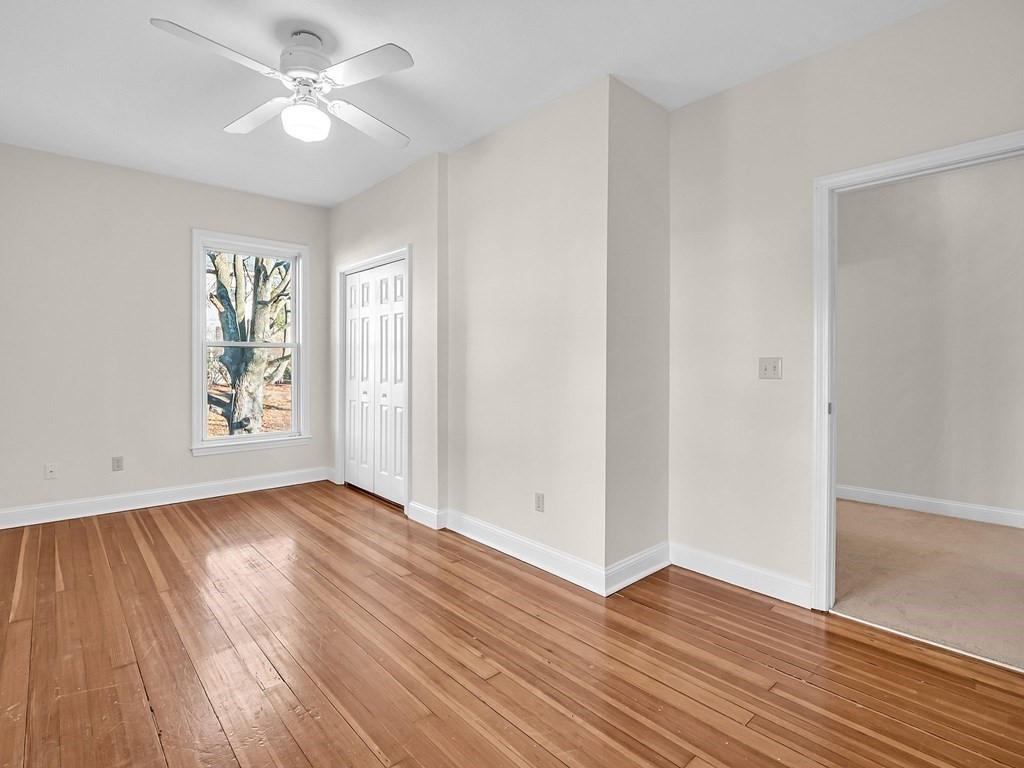 775 Bridge Street Lowell, MA 01850 - Photo 32 of 42 an empty room with wooden floor ceiling fan and windows