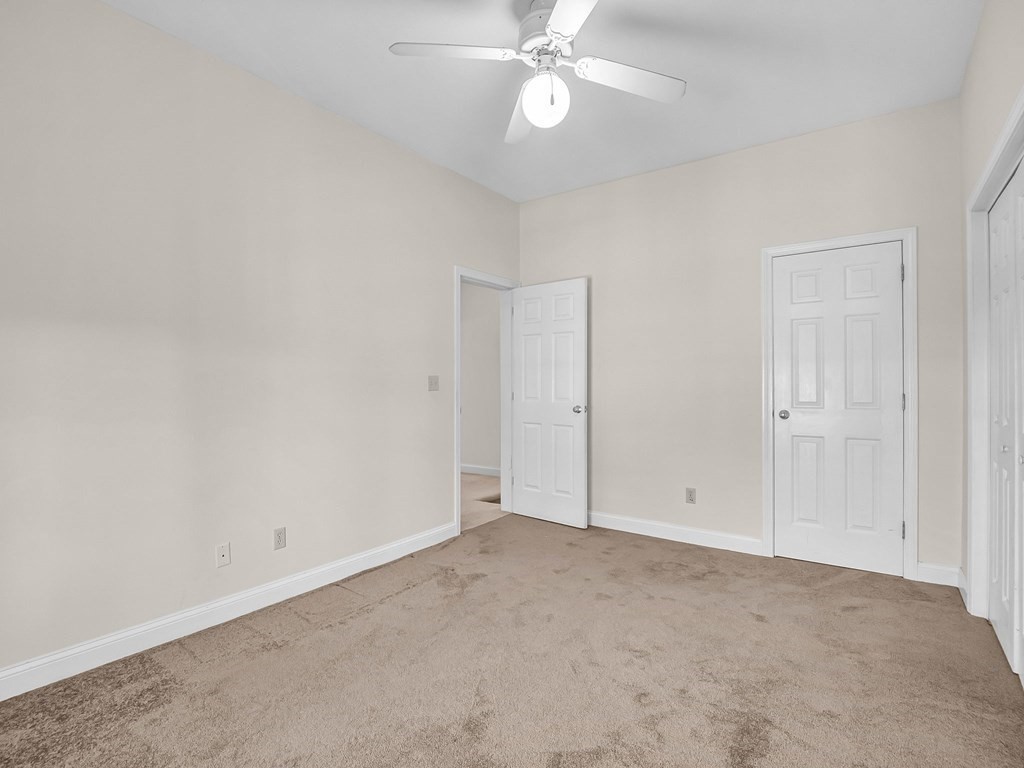 775 Bridge Street Lowell, MA 01850 - Photo 36 of 42 an empty room with a chandelier fan and closet
